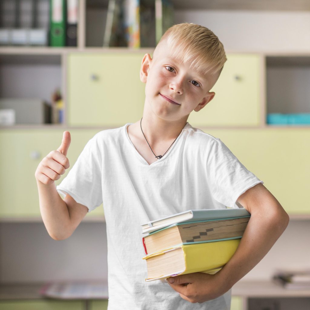 Happy kid holding books